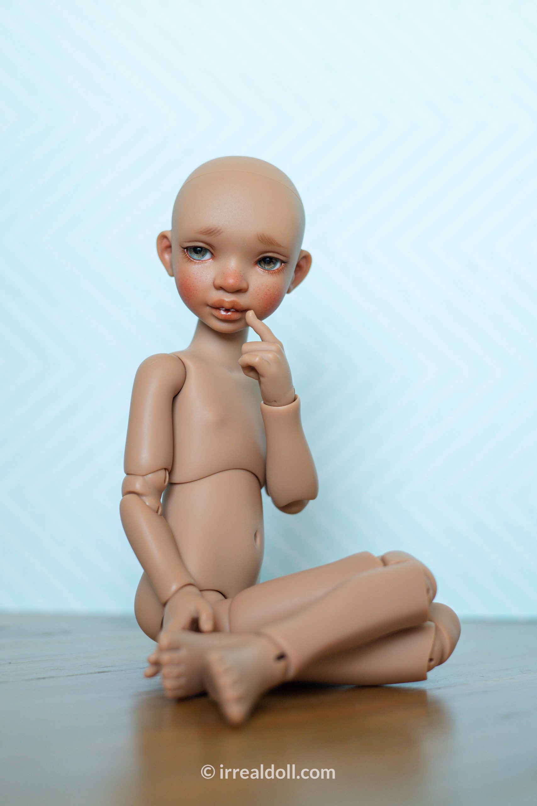 A picture of Surya, a 27cm tall doll from Irrealdoll in a dark skin tone.