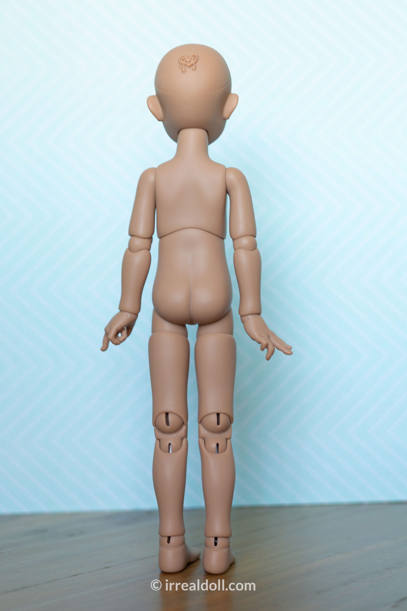 A picture of Surya, a 27cm tall doll from Irrealdoll in a dark skin tone.