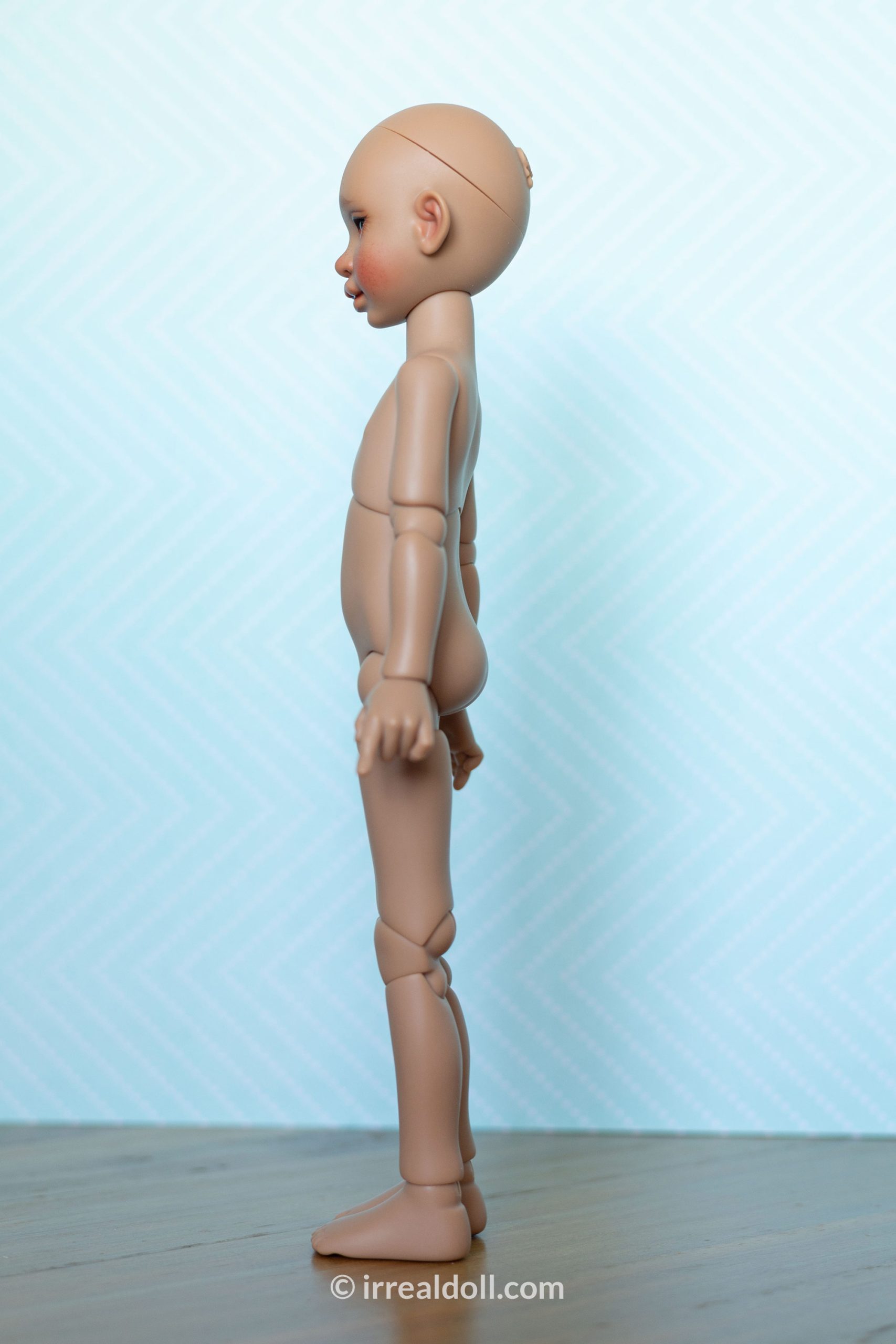 A picture of Surya, a 27cm tall doll from Irrealdoll in a dark skin tone.