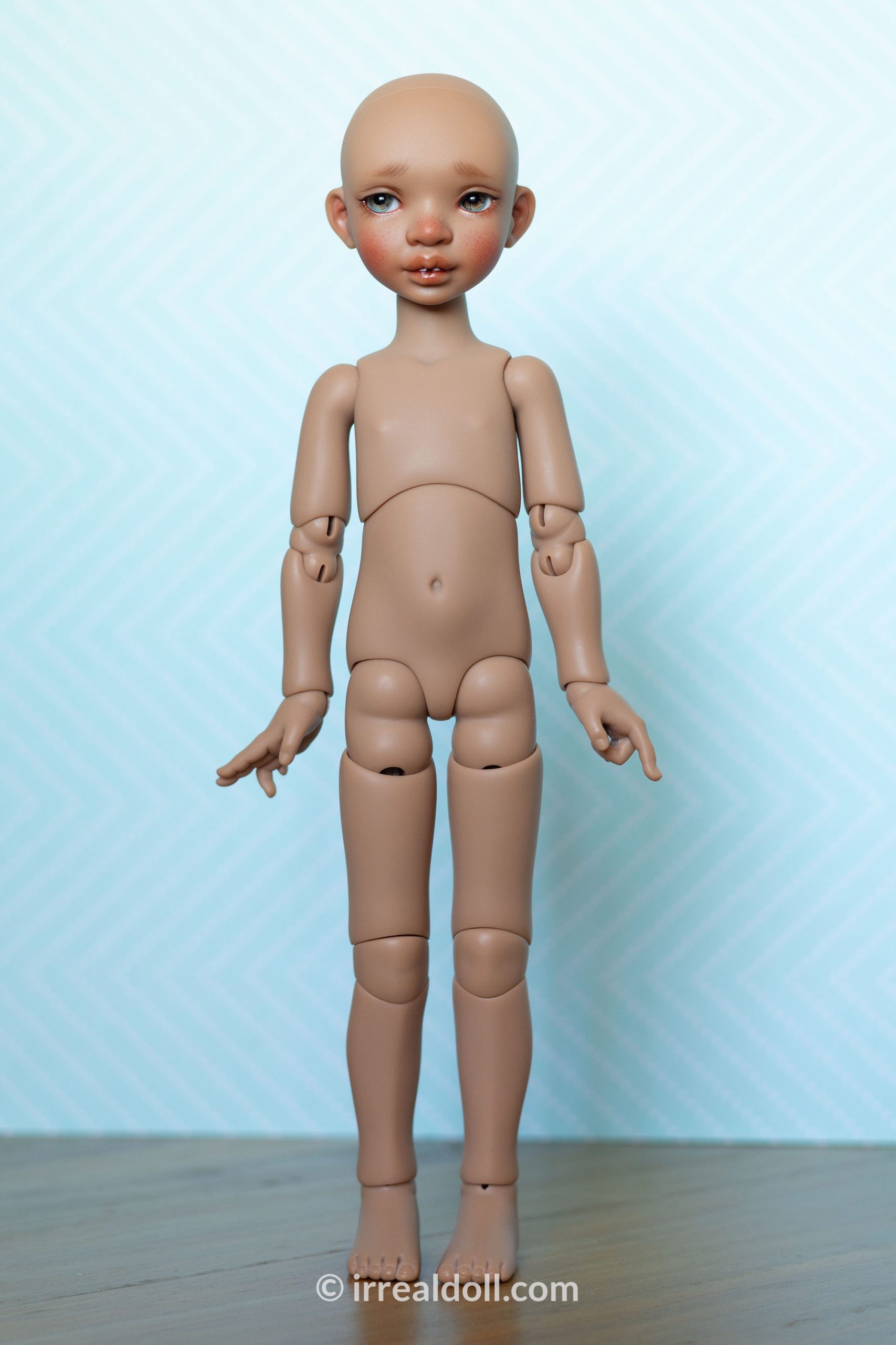 A picture of Surya, a 27cm tall doll from Irrealdoll in a dark skin tone.