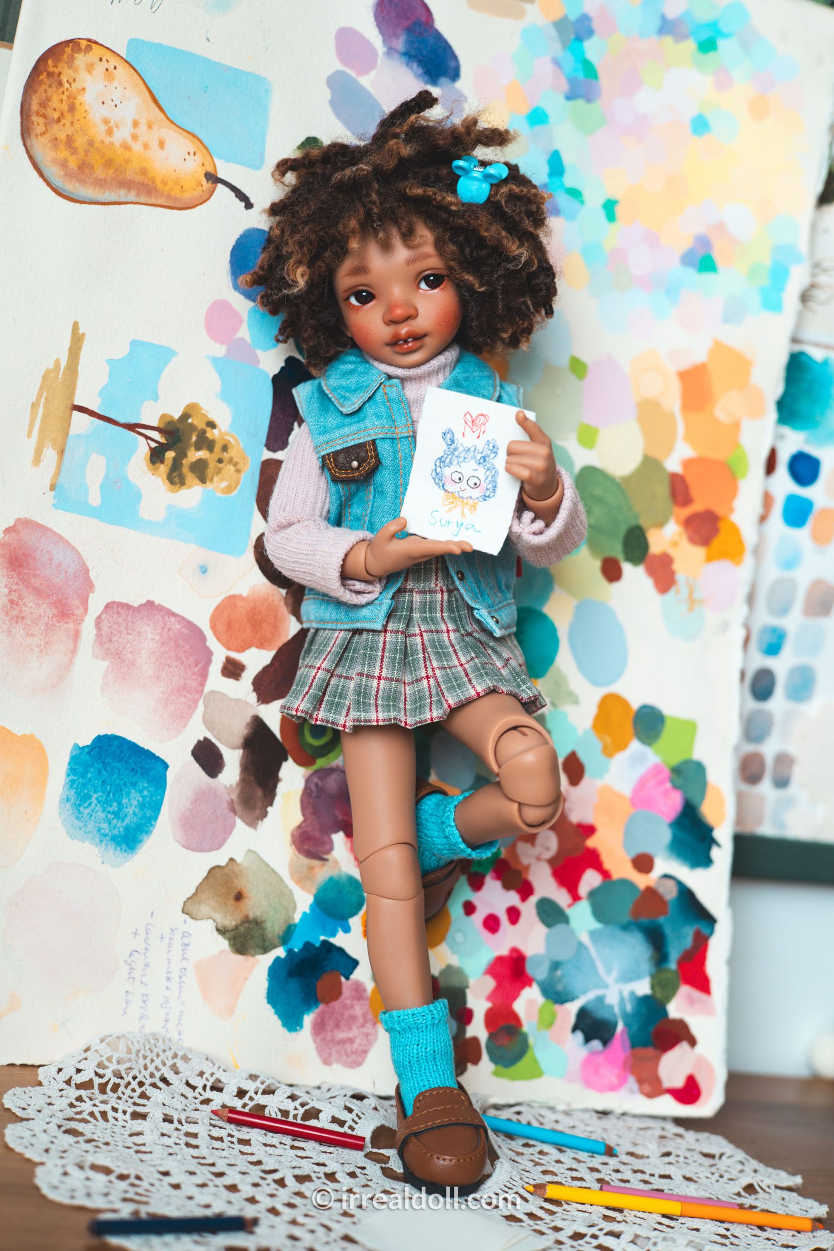 A picture of Surya, a 27cm tall doll from Irrealdoll in a dark skin tone.