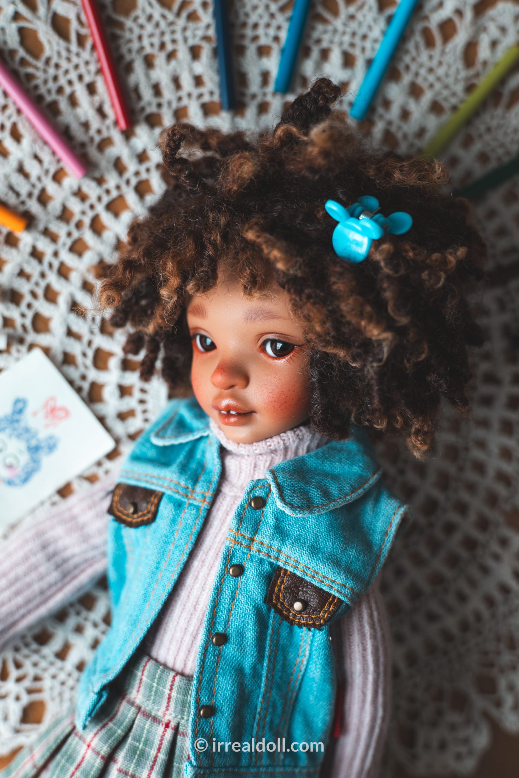 A picture of Surya, a 27cm tall doll from Irrealdoll in a dark skin tone.