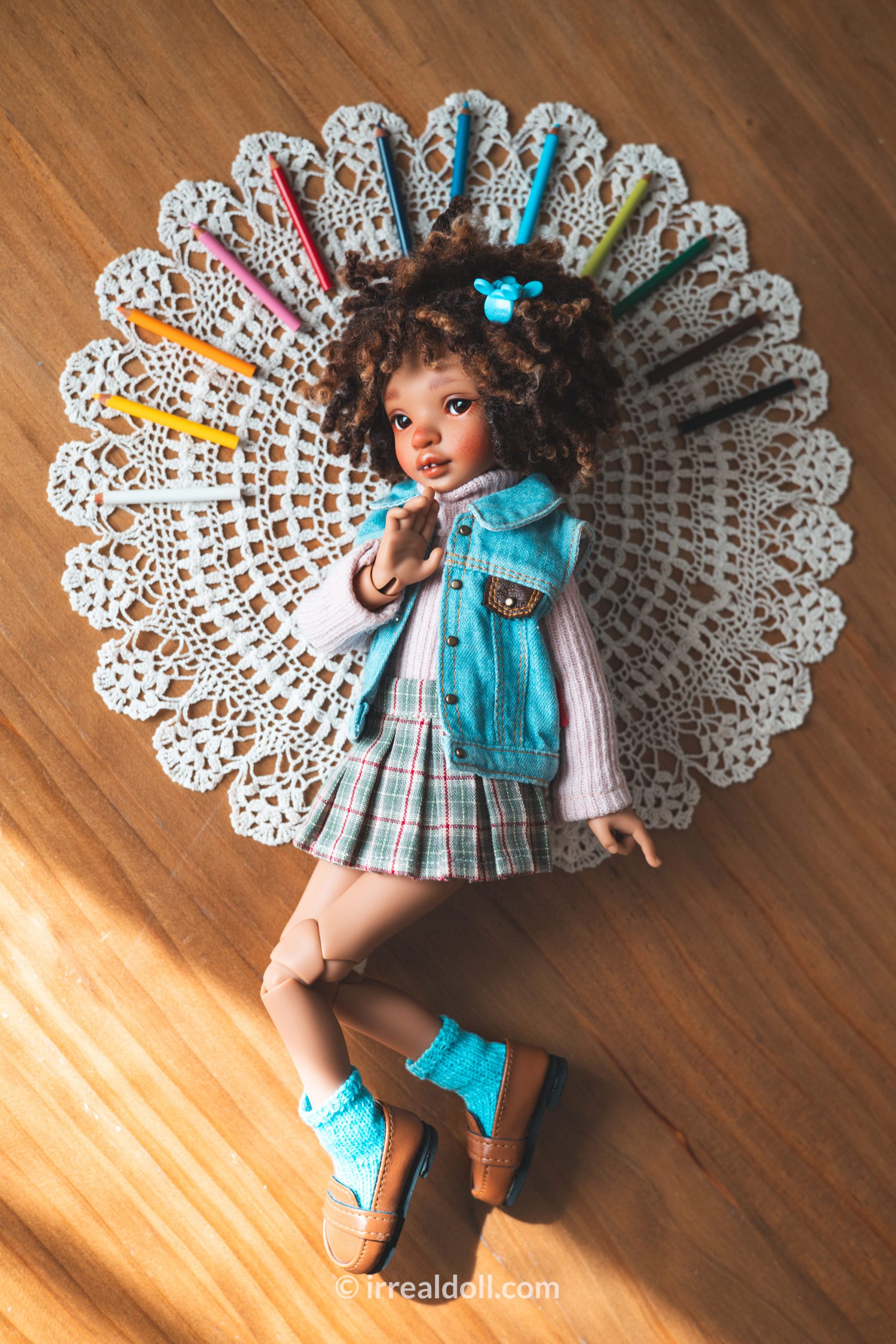 A picture of Surya, a 27cm tall doll from Irrealdoll in a dark skin tone.