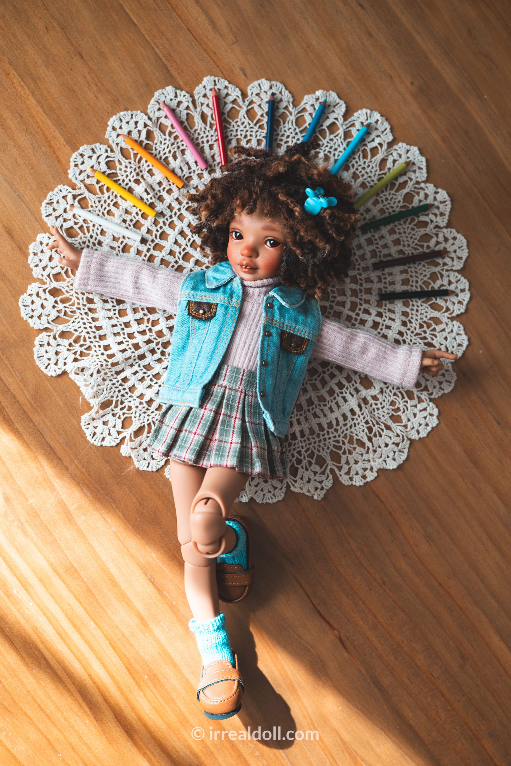 A picture of Surya, a 27cm tall doll from Irrealdoll in a dark skin tone.