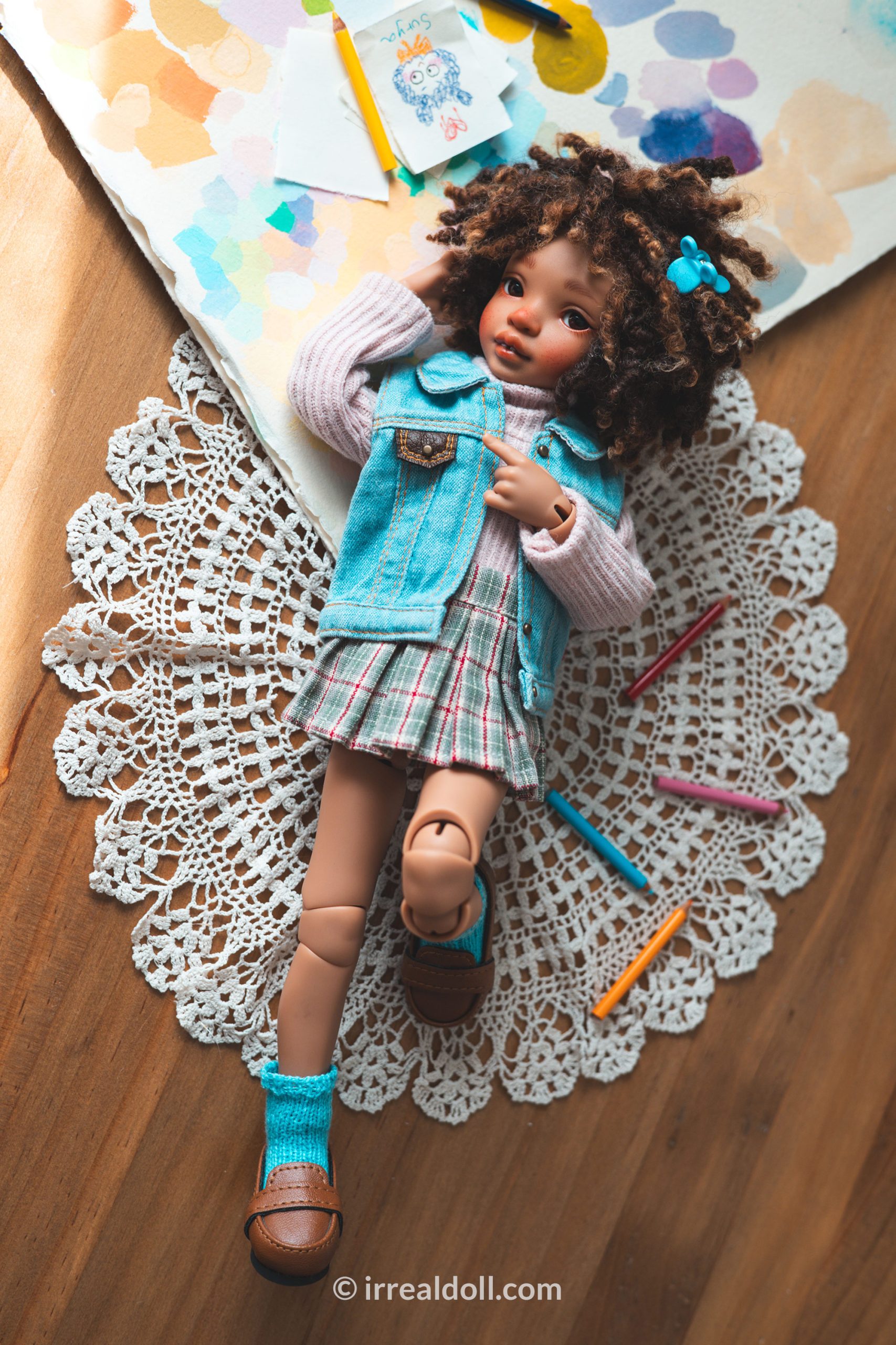 A picture of Surya, a 27cm tall doll from Irrealdoll in a dark skin tone.