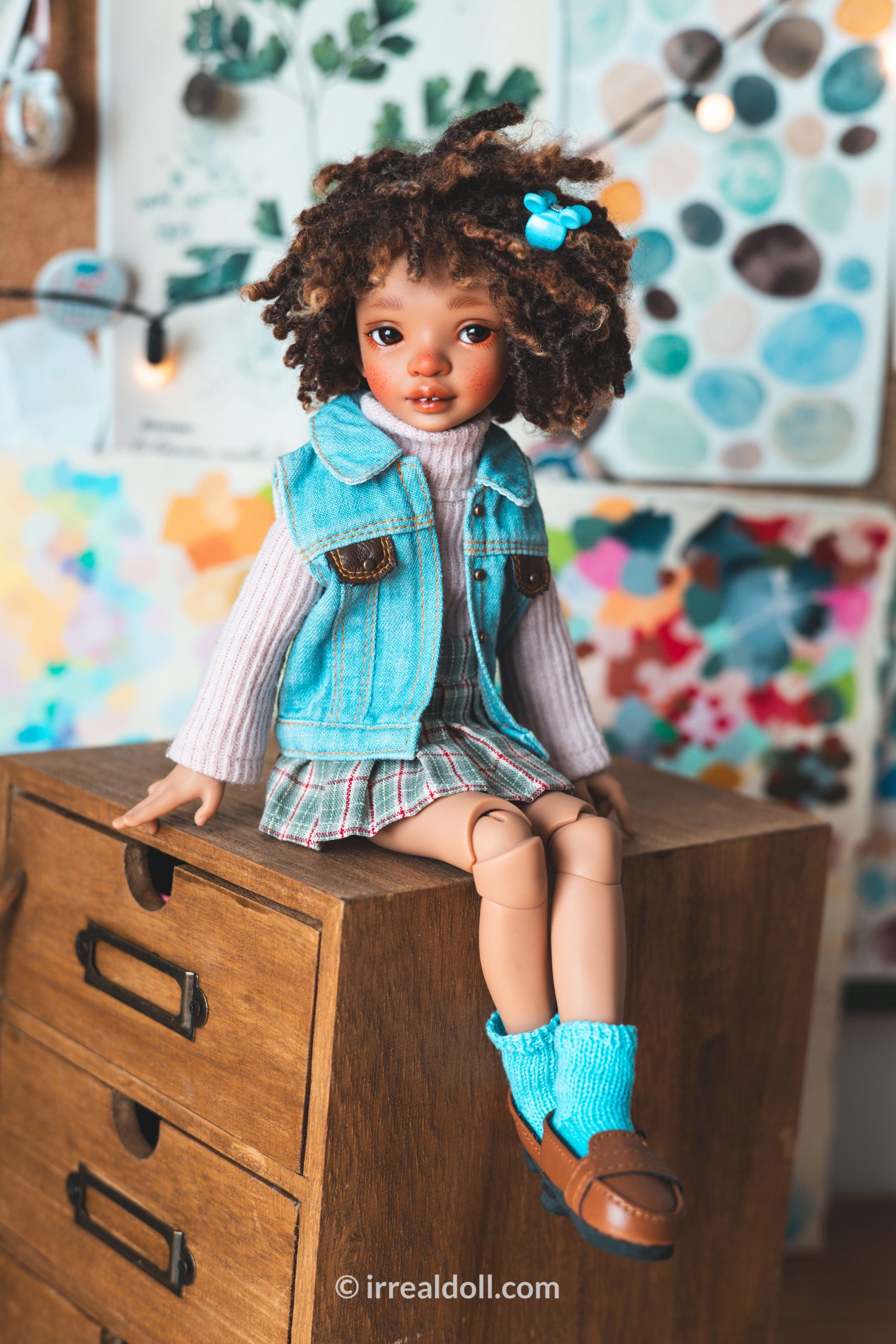 A picture of Surya, a 27cm tall doll from Irrealdoll in a dark skin tone.