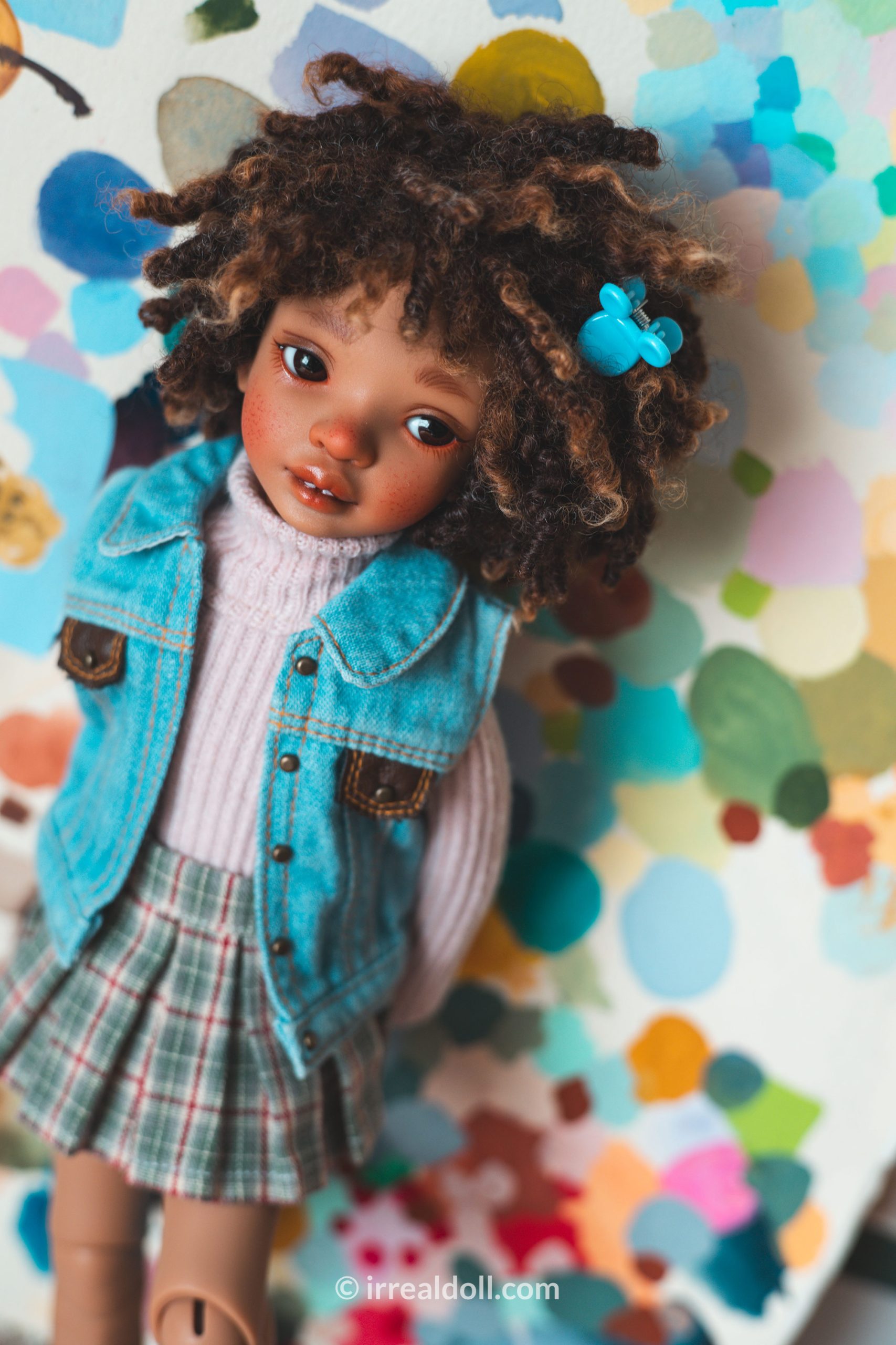 A picture of Surya, a 27cm tall doll from Irrealdoll in a dark skin tone.