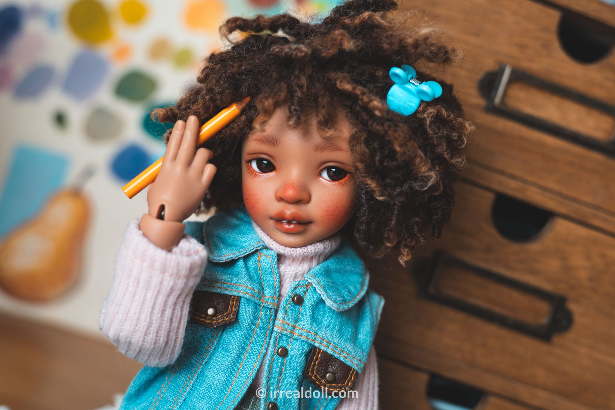 A picture of Surya, a 27cm tall doll from Irrealdoll in a dark skin tone.