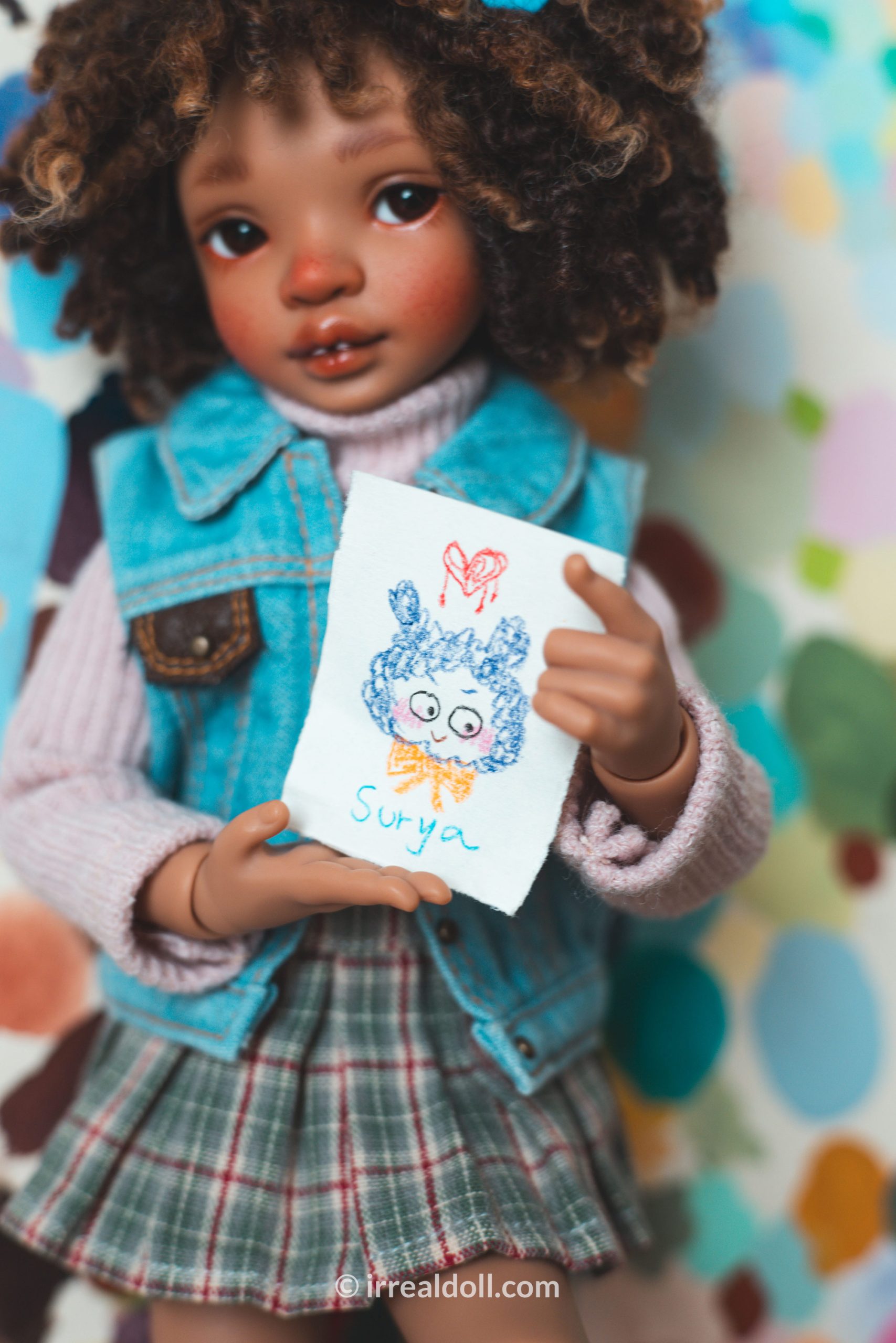 A picture of Surya, a 27cm tall doll from Irrealdoll in a dark skin tone.