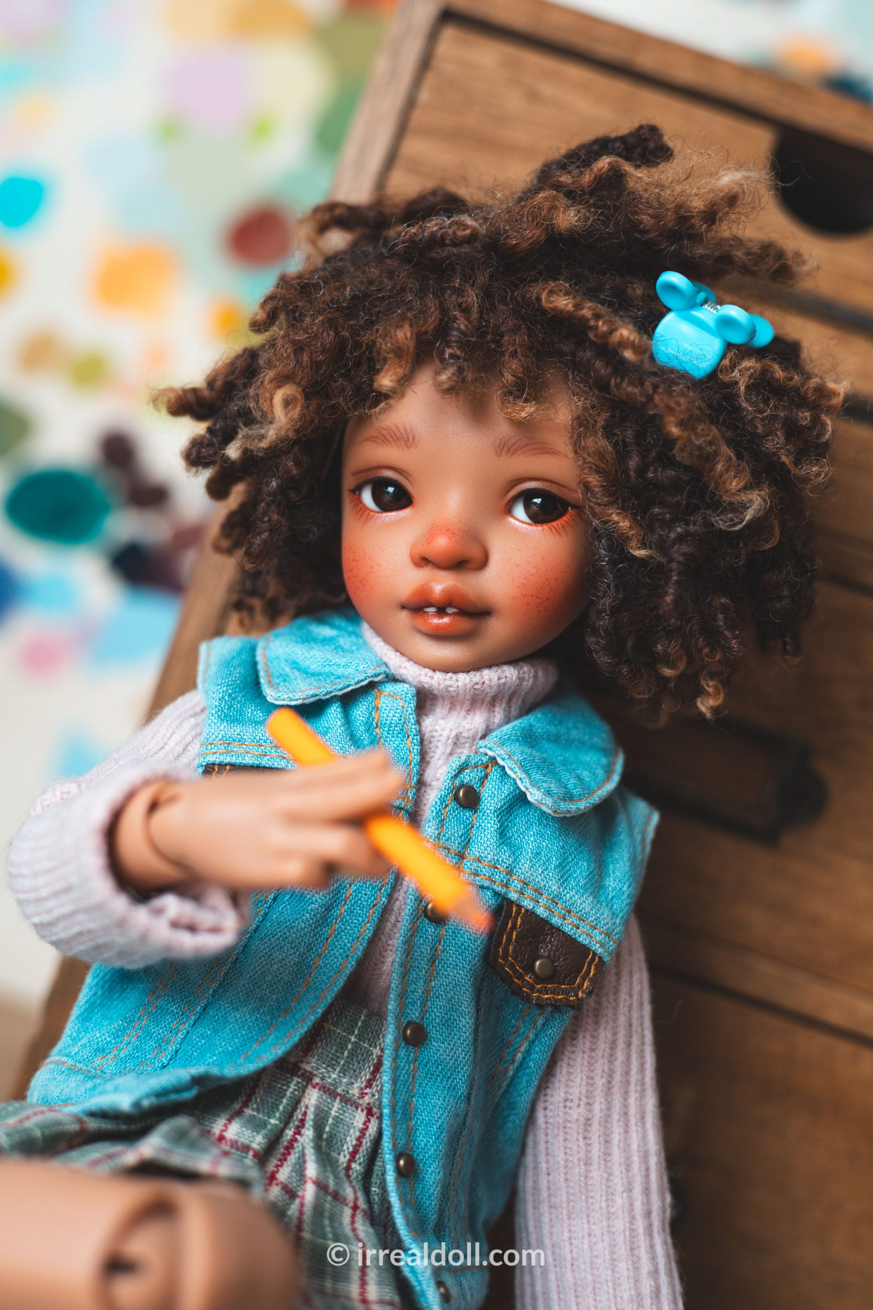 A picture of Surya, a 27cm tall doll from Irrealdoll in a dark skin tone.