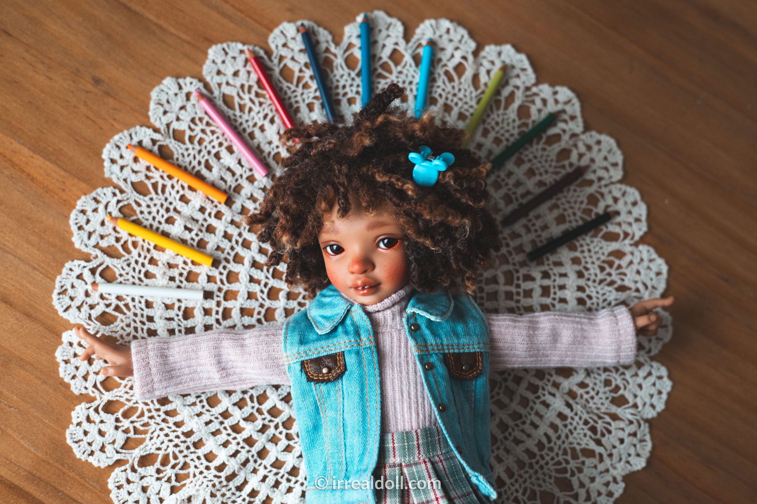A picture of Surya, a 27cm tall doll from Irrealdoll in a dark skin tone.