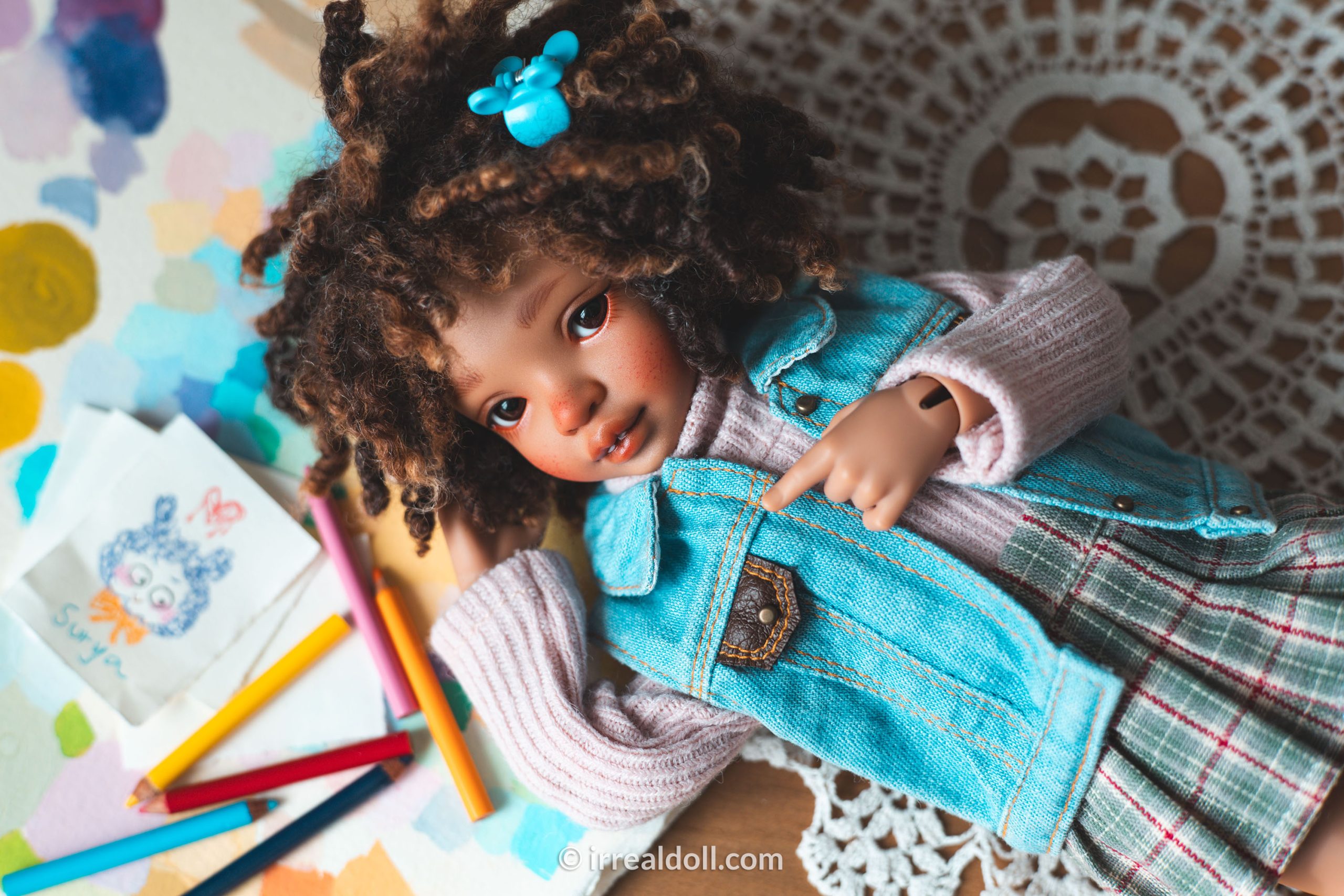 A picture of Surya, a 27cm tall doll from Irrealdoll in a dark skin tone.