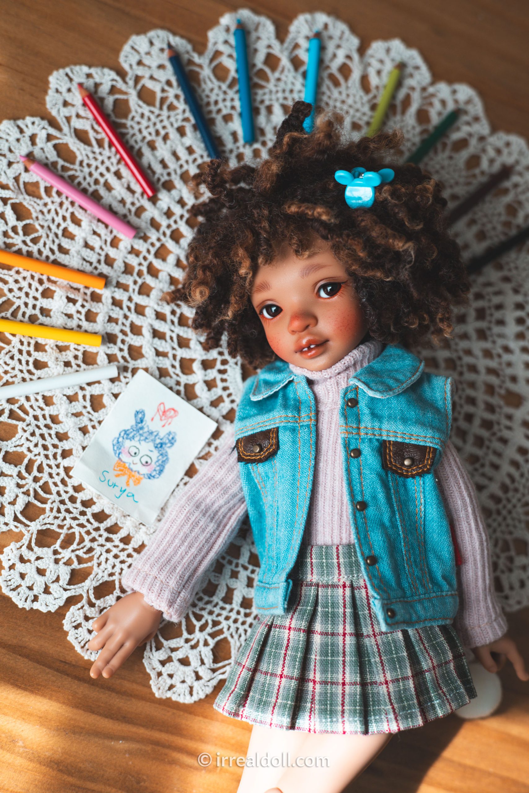 A picture of Surya, a 27cm tall doll from Irrealdoll in a dark skin tone.