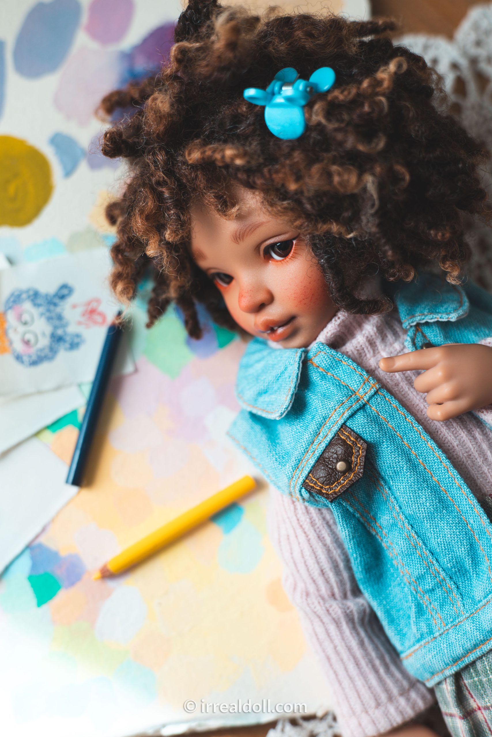 A picture of Surya, a 27cm tall doll from Irrealdoll in a dark skin tone.