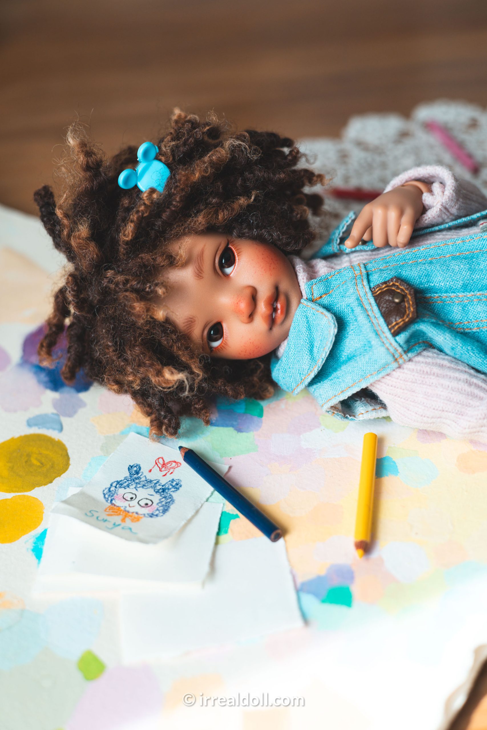 A picture of Surya, a 27cm tall doll from Irrealdoll in a dark skin tone.