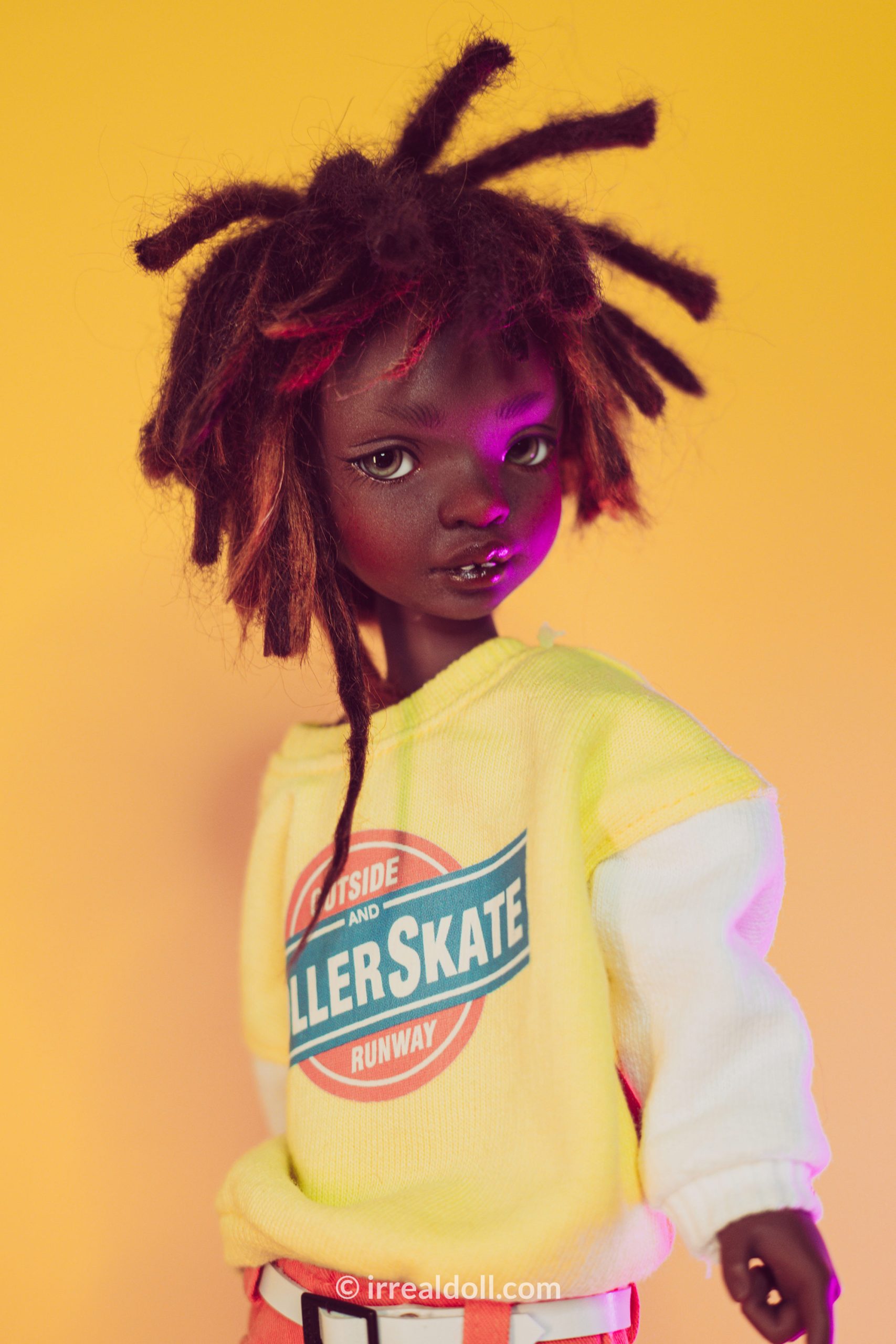 A picture of Surya, a 27cm tall doll from Irrealdoll in a dark skin tone.
