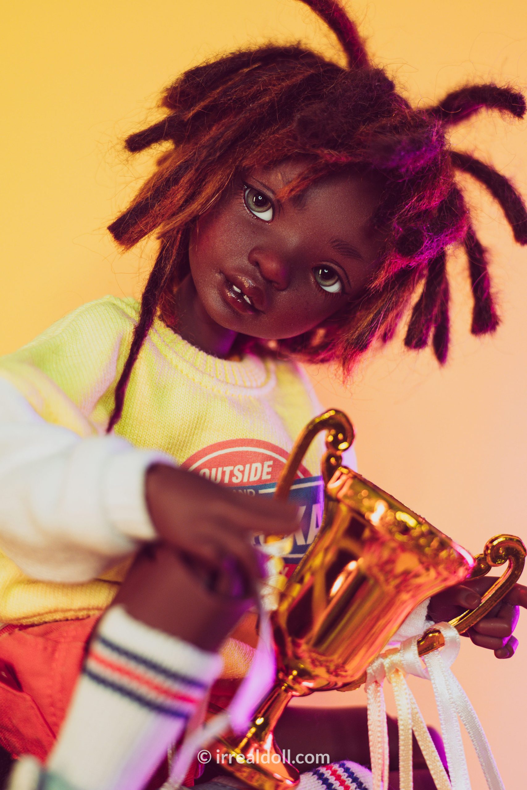 A picture of Surya, a 27cm tall doll from Irrealdoll in a dark skin tone.