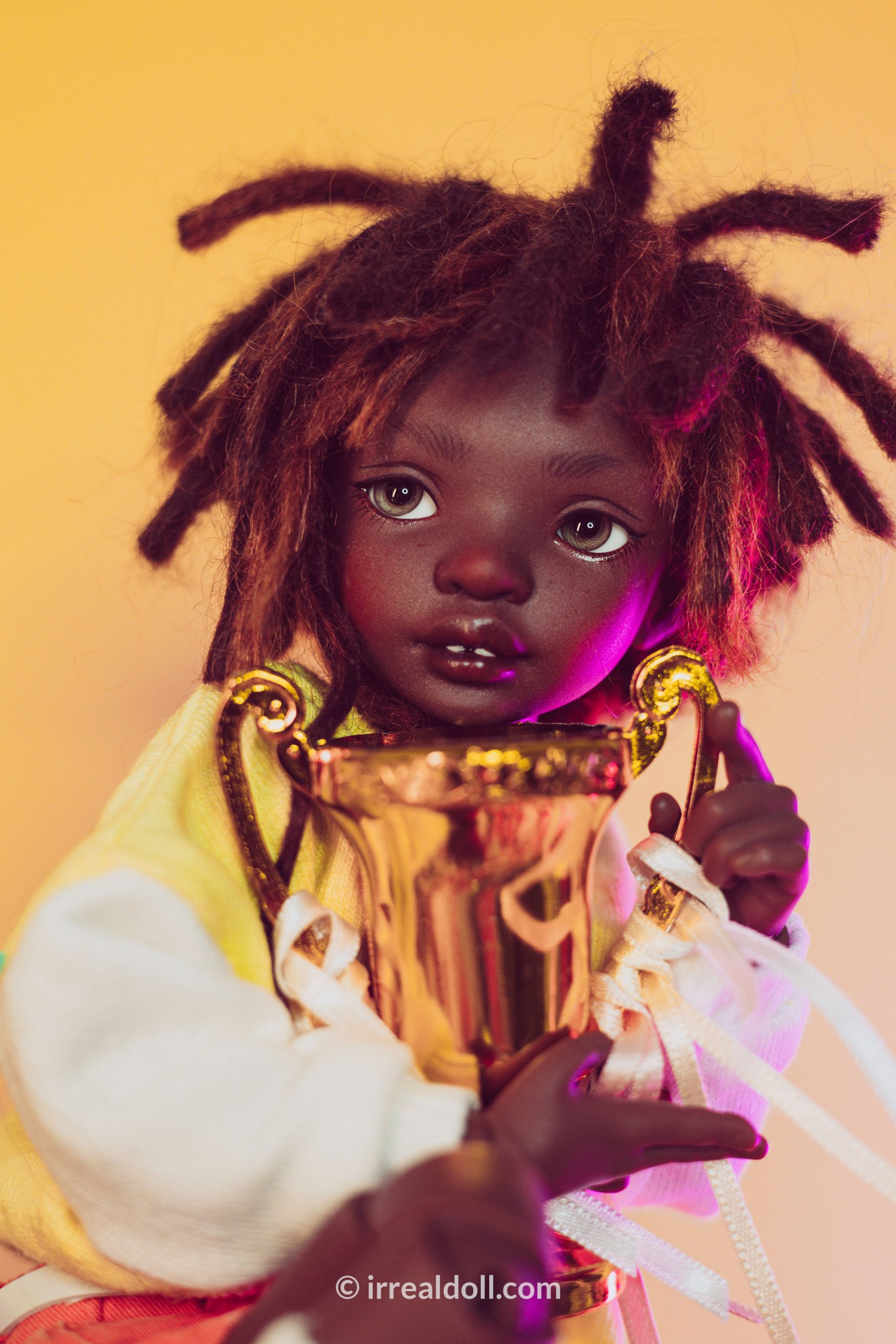A picture of Surya, a 27cm tall doll from Irrealdoll in a dark skin tone.