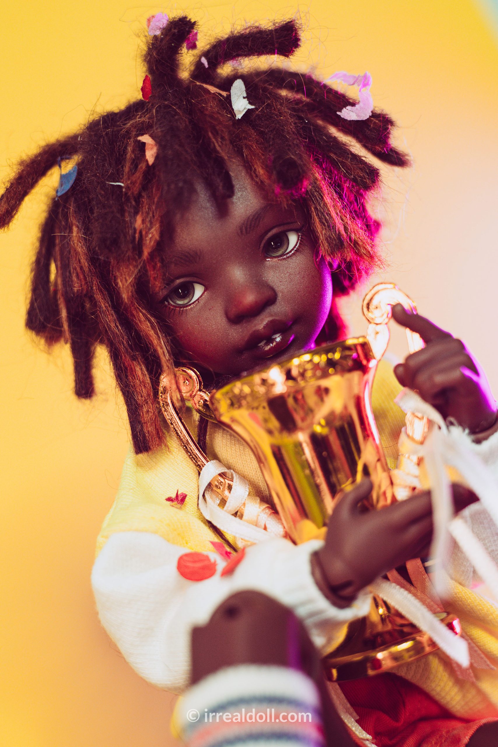 A picture of Surya, a 27cm tall doll from Irrealdoll in a dark skin tone.
