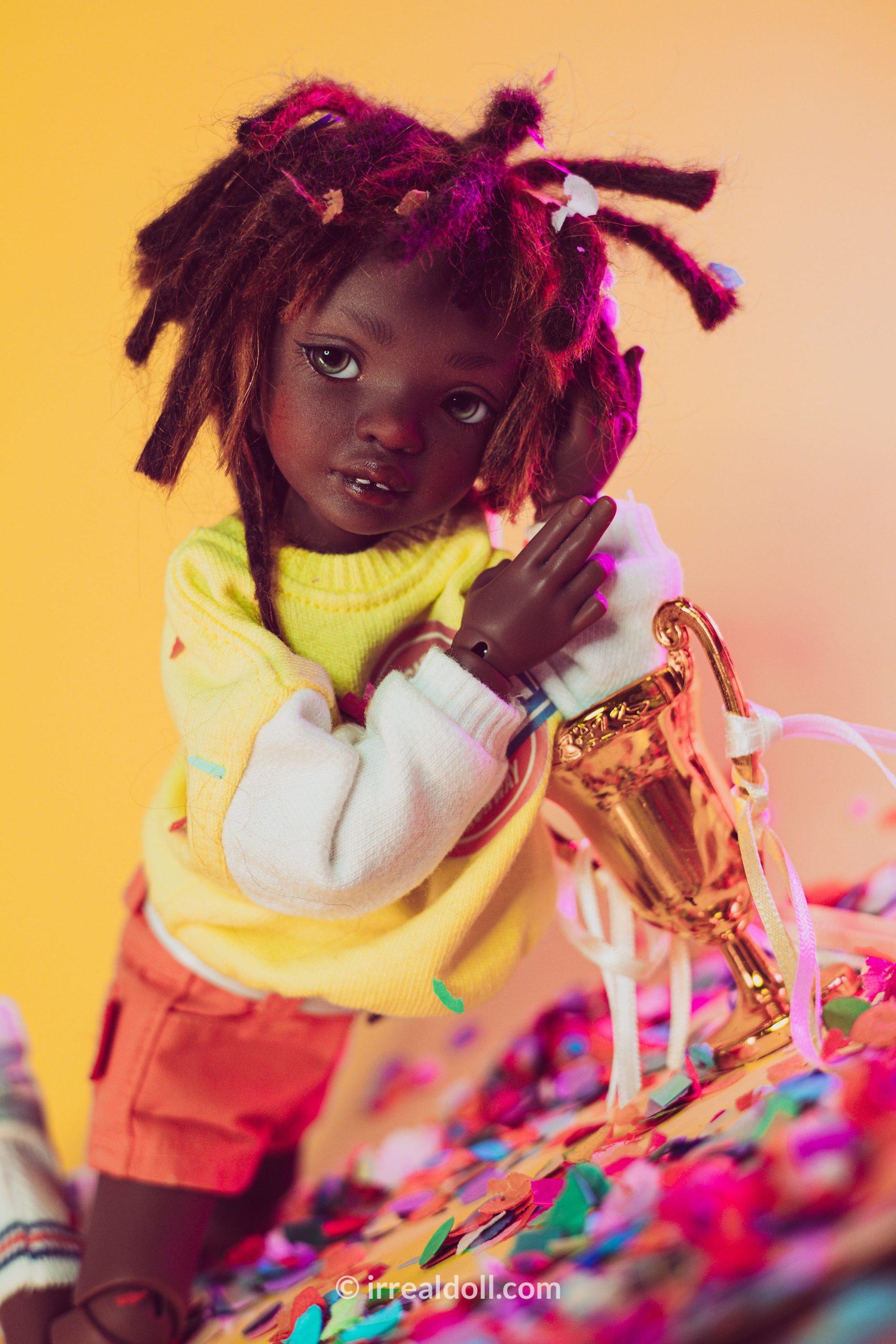 A picture of Surya, a 27cm tall doll from Irrealdoll in a dark skin tone.