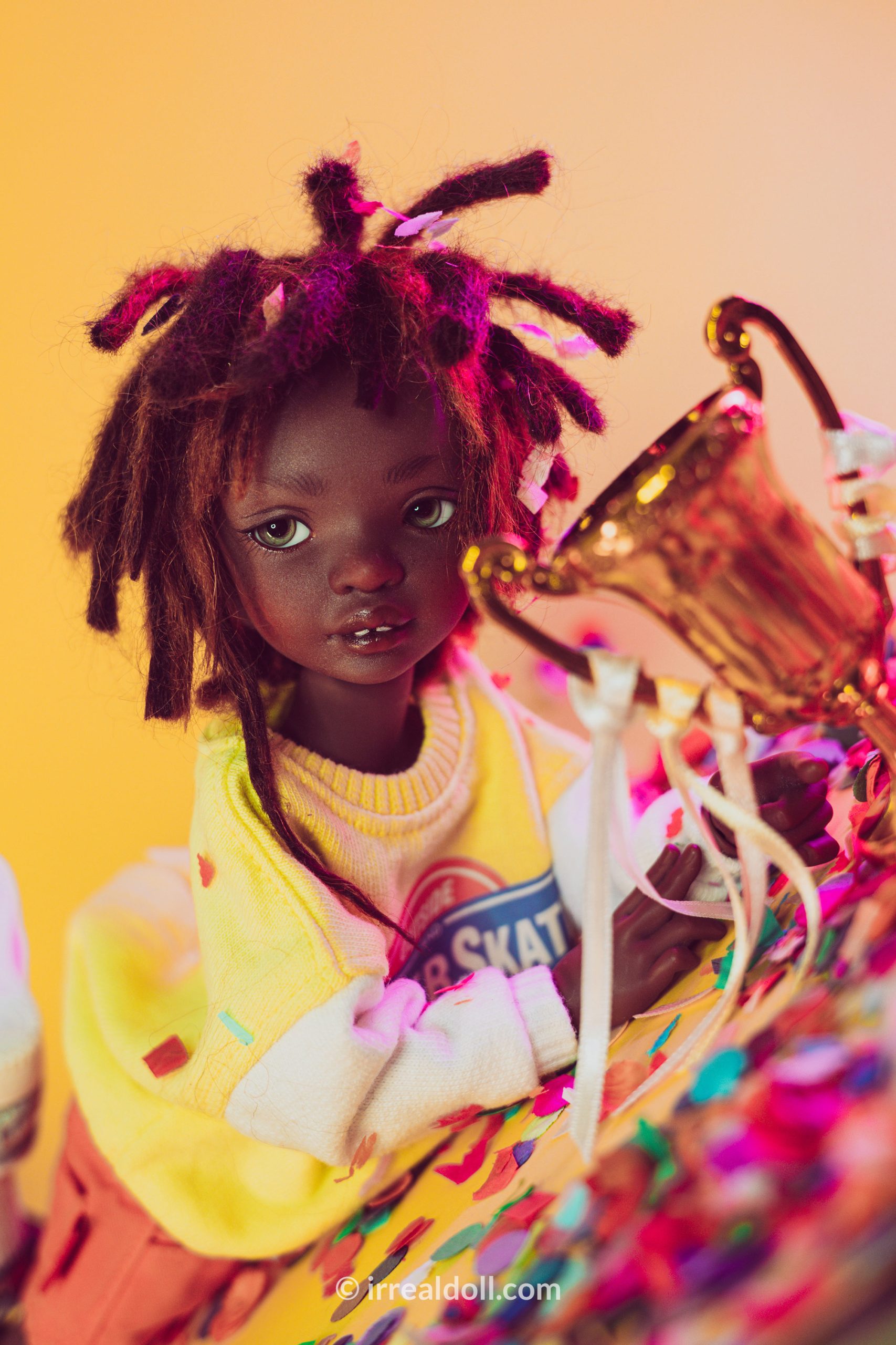 A picture of Surya, a 27cm tall doll from Irrealdoll in a dark skin tone.
